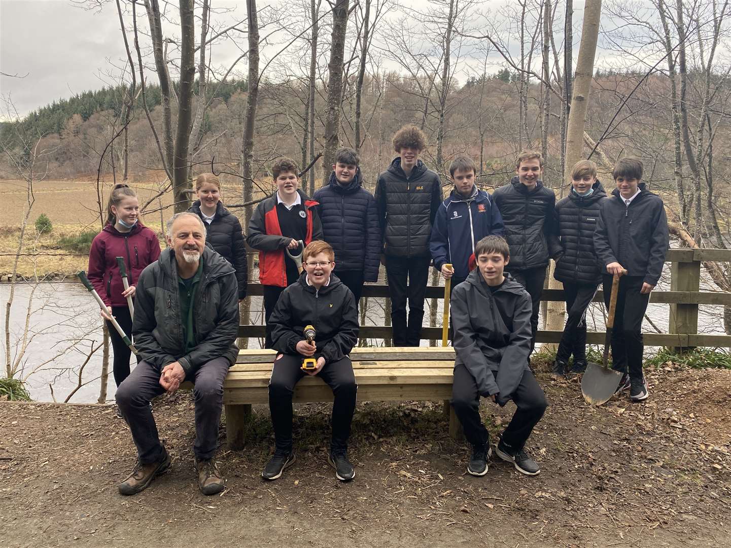 Moray Council Countryside Ranger Ged Connell and Speyside High School S3 pupils with the new bench.