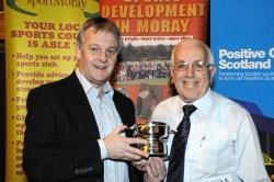 Peter Robertson (right) receives his award from Neil Cruickshanks of Campbell and McConnachie.