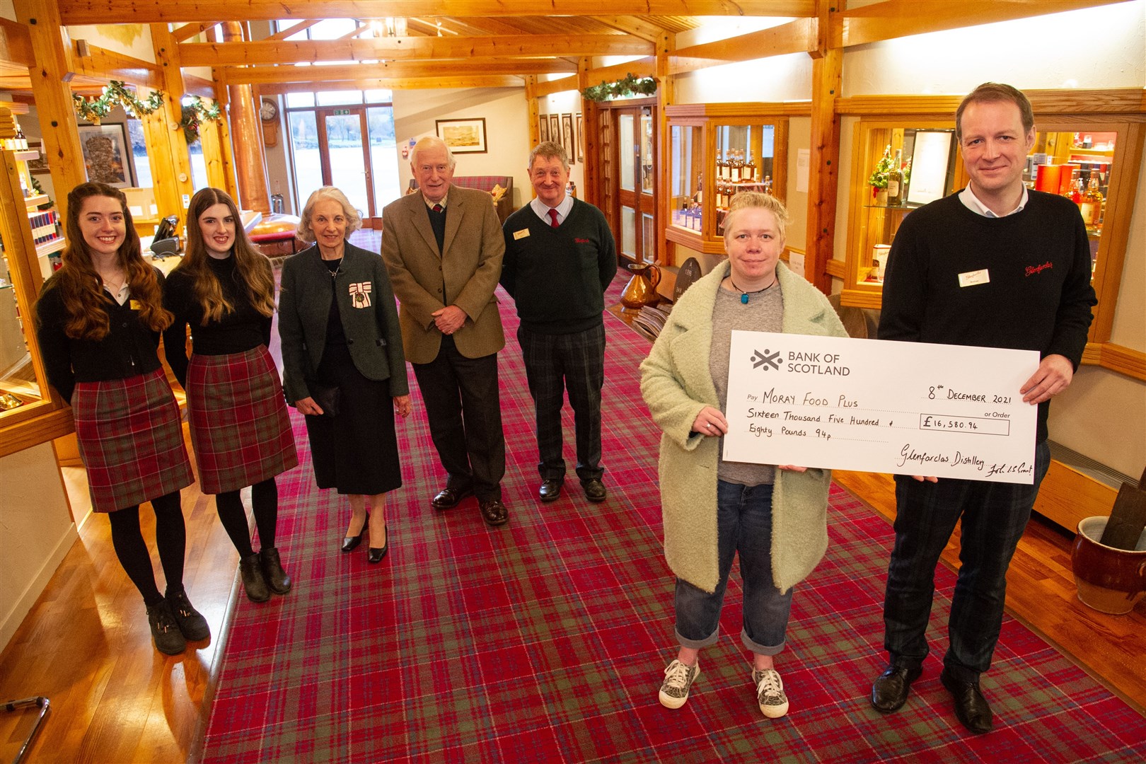 Mairi McCallum, Moray Food Plus project manager, is presented with a cheque by Glenfarclas visitor centre manager Matthew Porritt. They are joined by (from left) Lauren MacDonald, Kirstin MacDonald, Vice Lord-Lieutenant of Banffshire Patricia Seligman, Lord-Lieutenant of Moray Seymour Monro and Steve Allan. Picture: Daniel Forsyth.