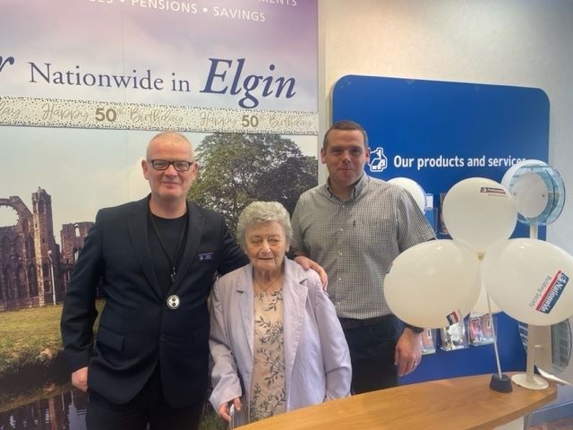 Nationwide in Elgin celebrated their 50th anniversary with a visit from Douglas Ross (right) and Mrs Doyle, one of their longest-serving members (centre). They are joined by branch manager Gordon Glen.