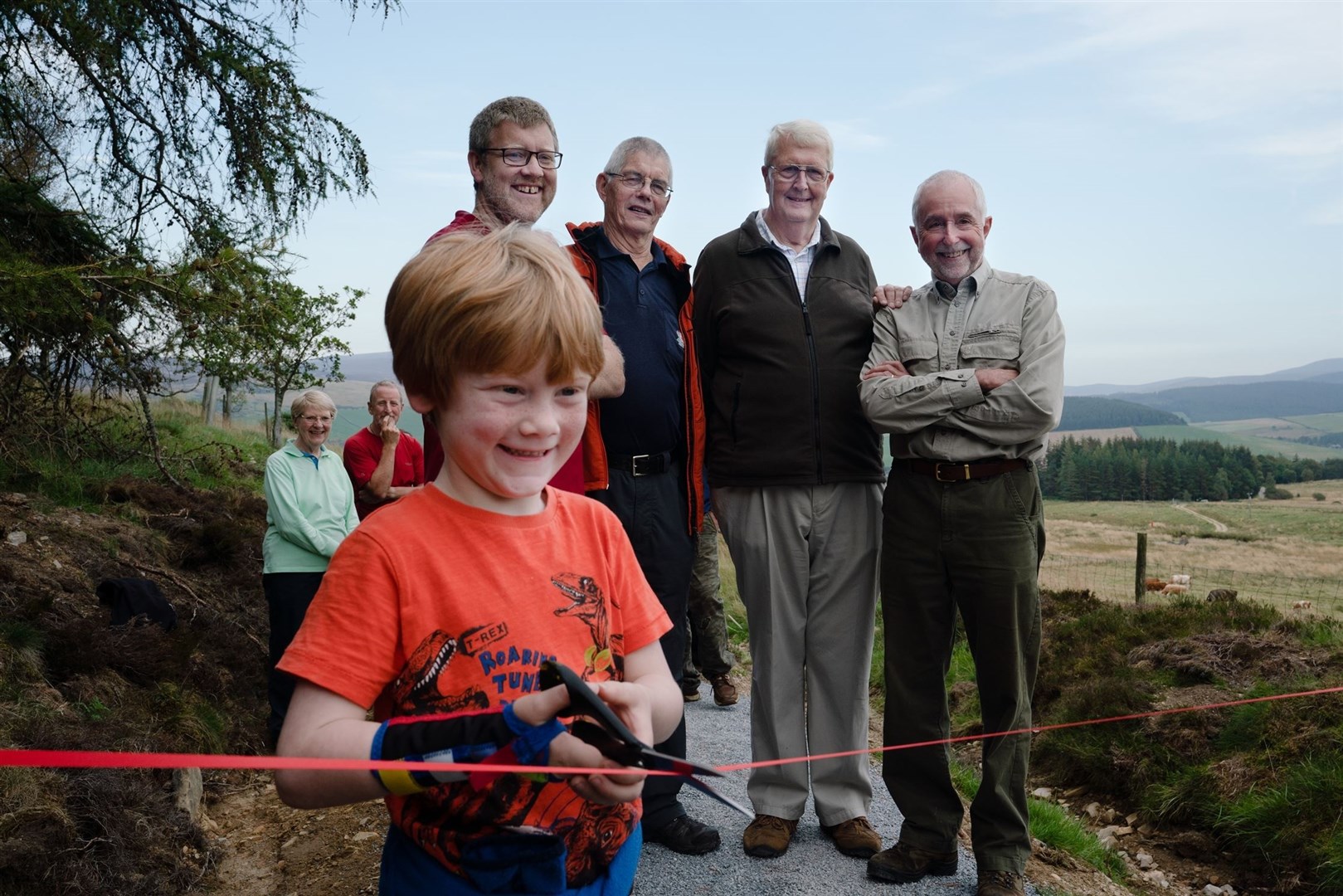 Henry Moir, aged 7, cutting the ribbon. Also pictured are Grant Moir of the Cairngorms National Park Authority, Tony Birchall and Brian Fowler of the Glenlivet Walking Group and Steve Smith of the Tomintoul and Glenlivet Landscape Partnership.