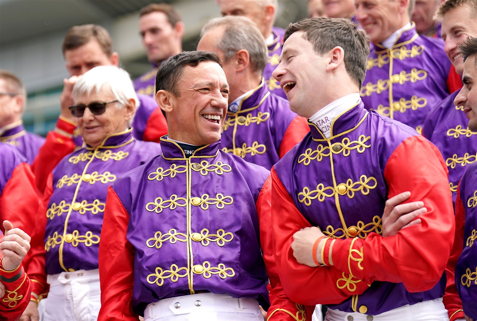 Frankie Dettori (left) and Oisin Murphy with other jockeys who have ridden horses for the Queen in the past on Derby Day at Epsom (PA)