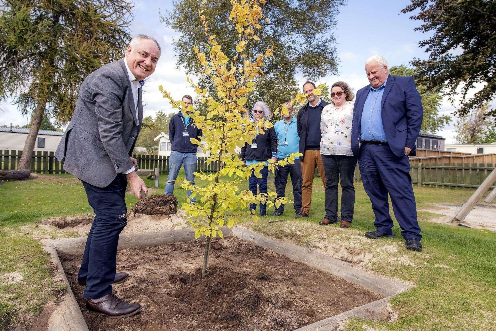 Scottish Tourism Minister Richard Lochhead MSP plants the commemorative hornbeam at the Findhorn park.