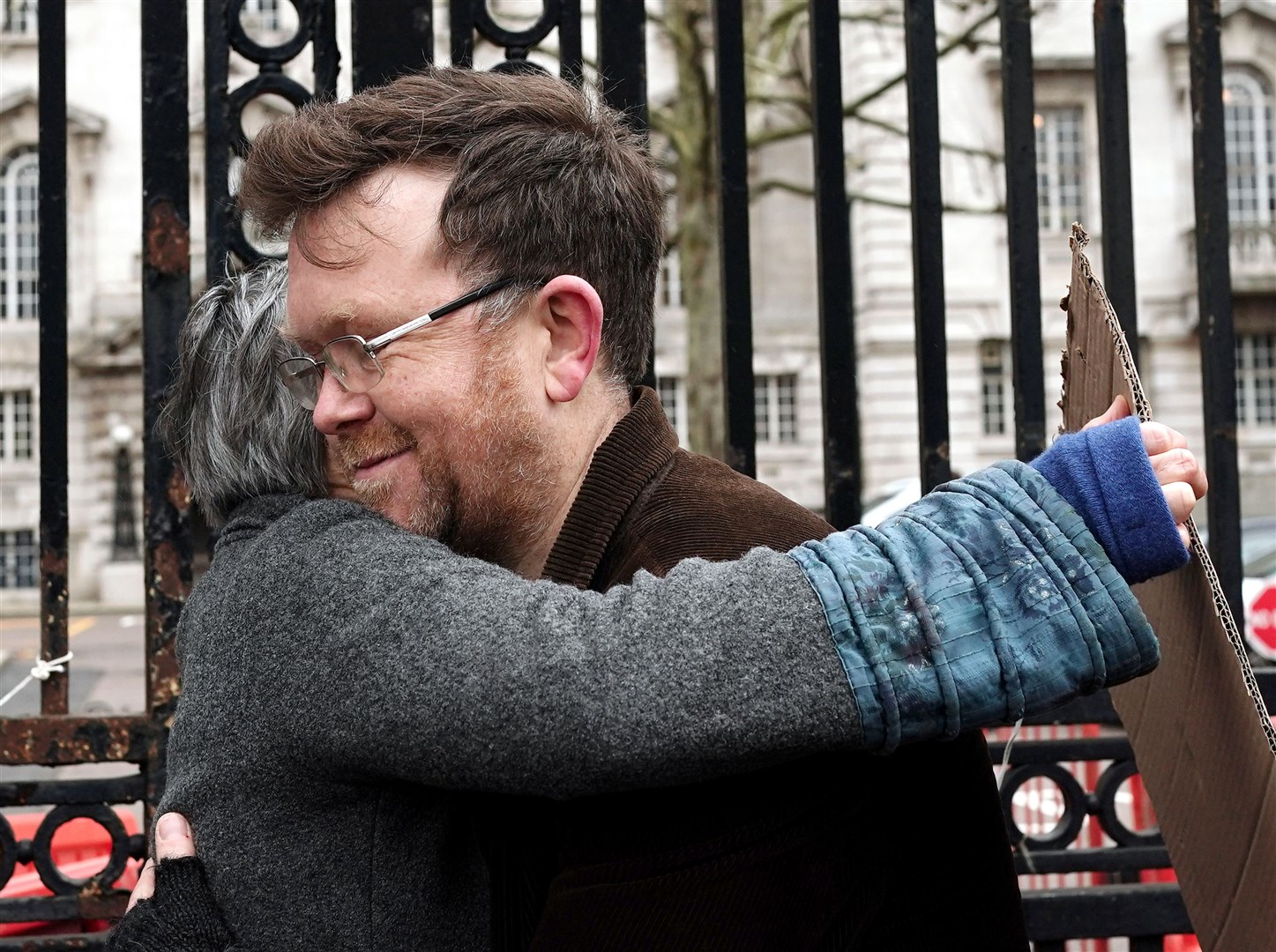 Oliver Rock is hugged by fellow campaigner Ruth Cook outside Inner London Crown Court (Jordan Pettitt/PA)