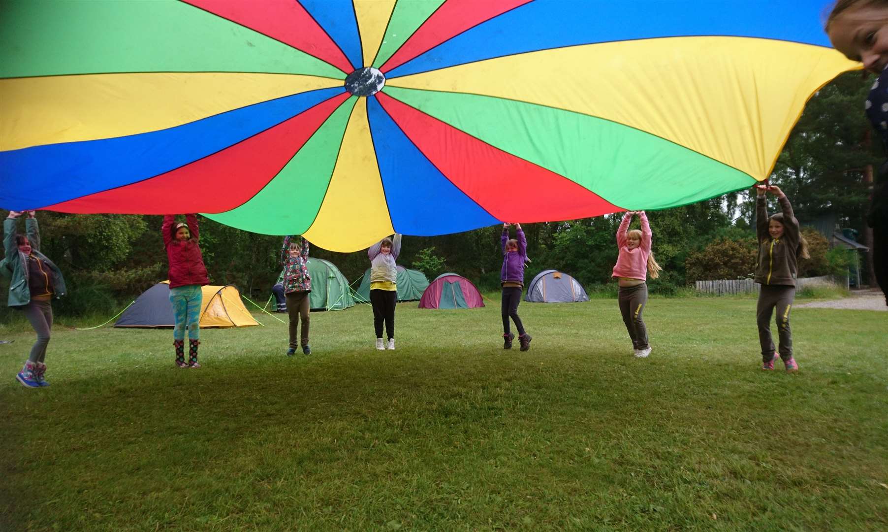 1st Cullen and 2nd Fochabers Brownies enjoy playing with the parachute.