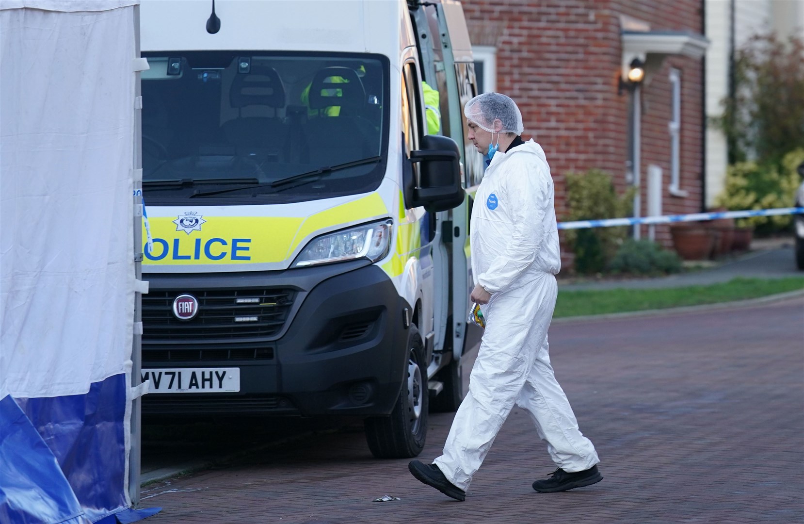 A forensic investigator outside a house in Costessey near Norwich after four people were found dead inside the property. Norfolk Constabulary said officers forced their way into an address in Allan Bedford Crescent, Costessey, shortly before 7am following a call from a member of the public. The bodies of four people were found inside and the force believes they were all known to each other. Picture date: Friday January 19, 2024.