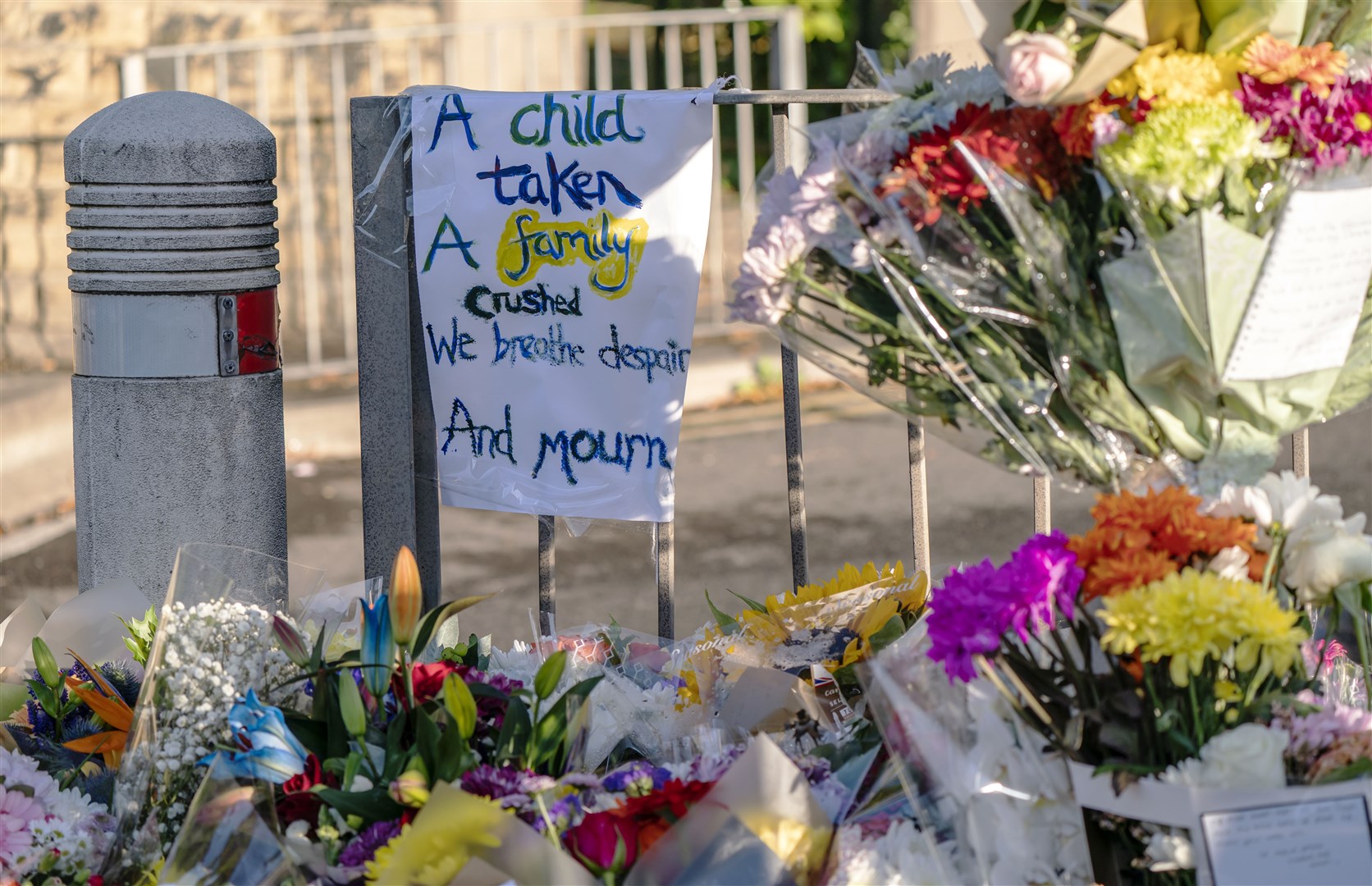 Tributes at the scene in Woodhouse Hill, Huddersfield, where 15-year-old schoolboy Khayri McLean was fatally stabbed (Danny Lawson/PA)