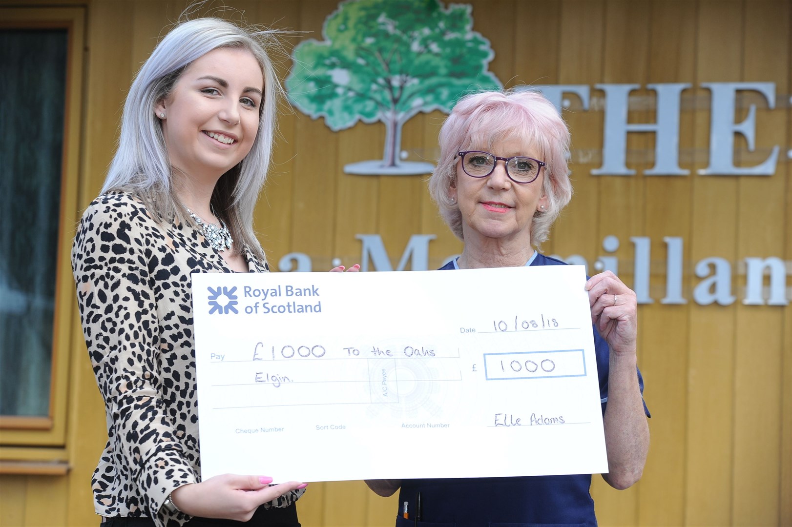 Elle adams [left] hands over a cheque for £1000 to unit manager at the oaks hospice Mhari McFadden in 2018.