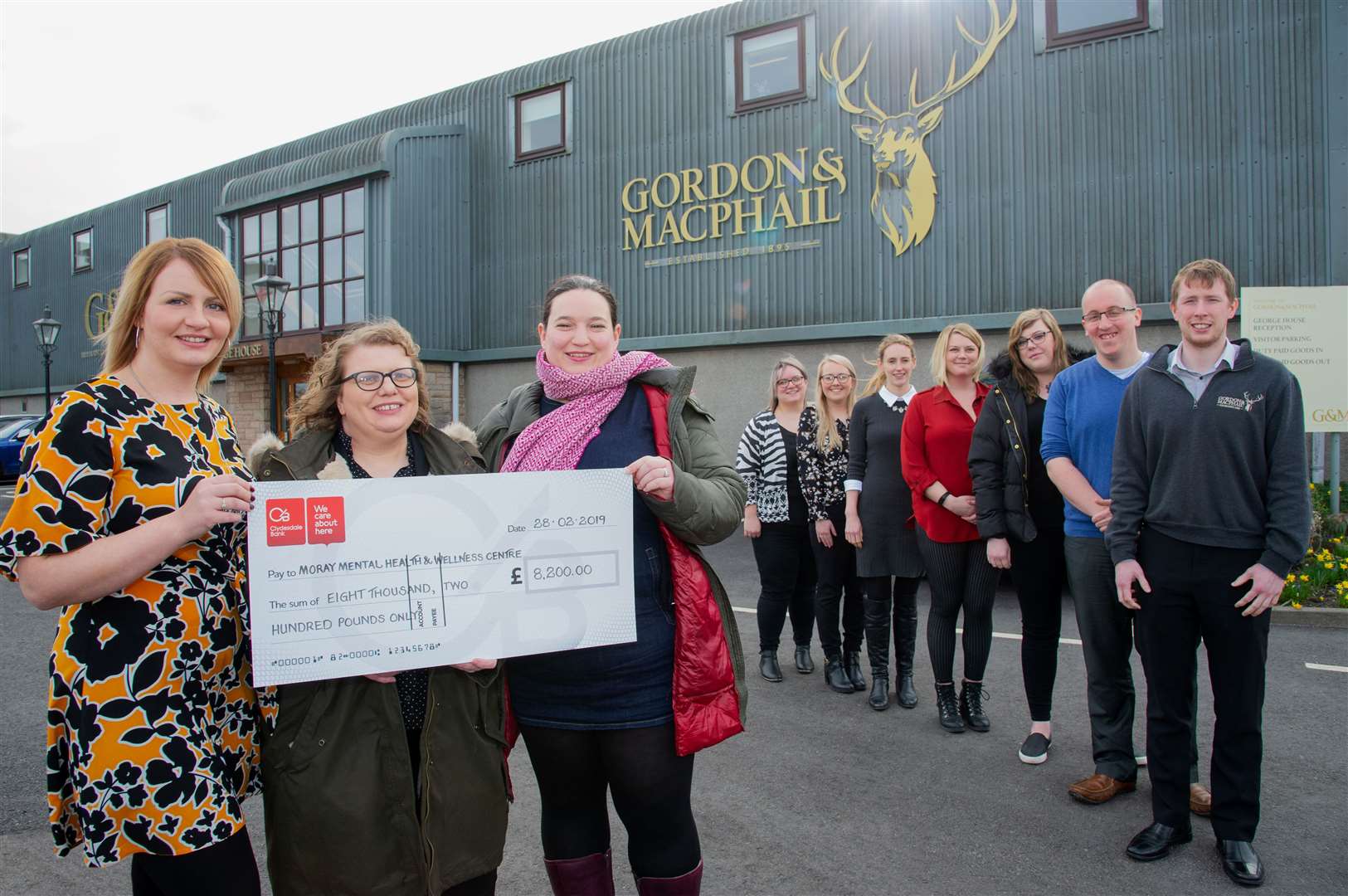 Jodie Clayton (left), HR administrator at Gordon and MacPhail, is joined by fellow colleagues to present £8200 to Karen Dunnett (centre) and Louise Parkinson of the Moray Mental Health & Wellness Centre.