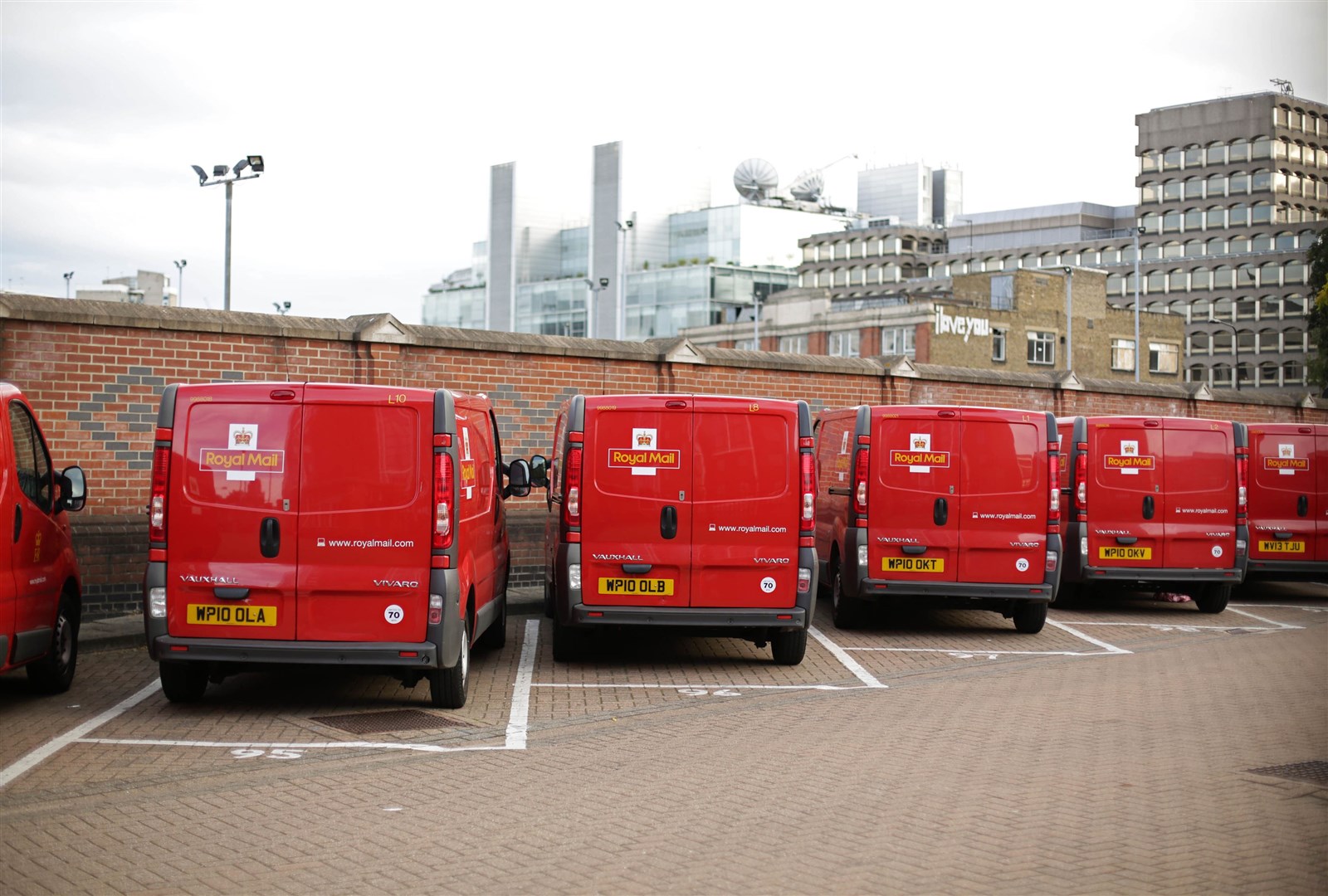 A row of Royal Mail delivery vans parked at Mount Pleasant Mail Centre in London (Yui Mok/PA)