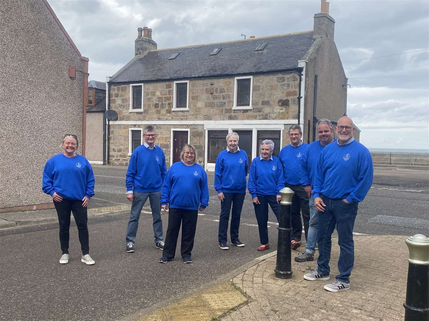 Moving forward...Portgordon Community Trust chairman Scott Sliter (right) and fellow group members have plenty to smile about after winning a £155,000 grant to purchase the former Richmond Arms.