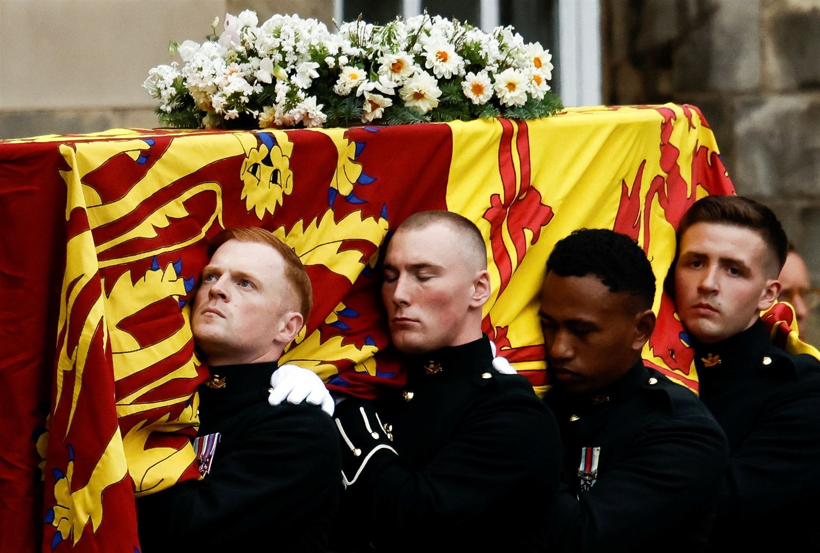 Pallbearers carry the Queen’s coffin as it arrives at Holyroodhouse (Alkis Konstantinidis/PA)