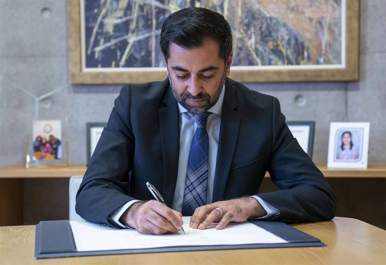 Outgoing First Minister Humza Yousaf signs his official resignation letter at the Scottish Parliament in Edinburgh. (Jane Barlow/PA)