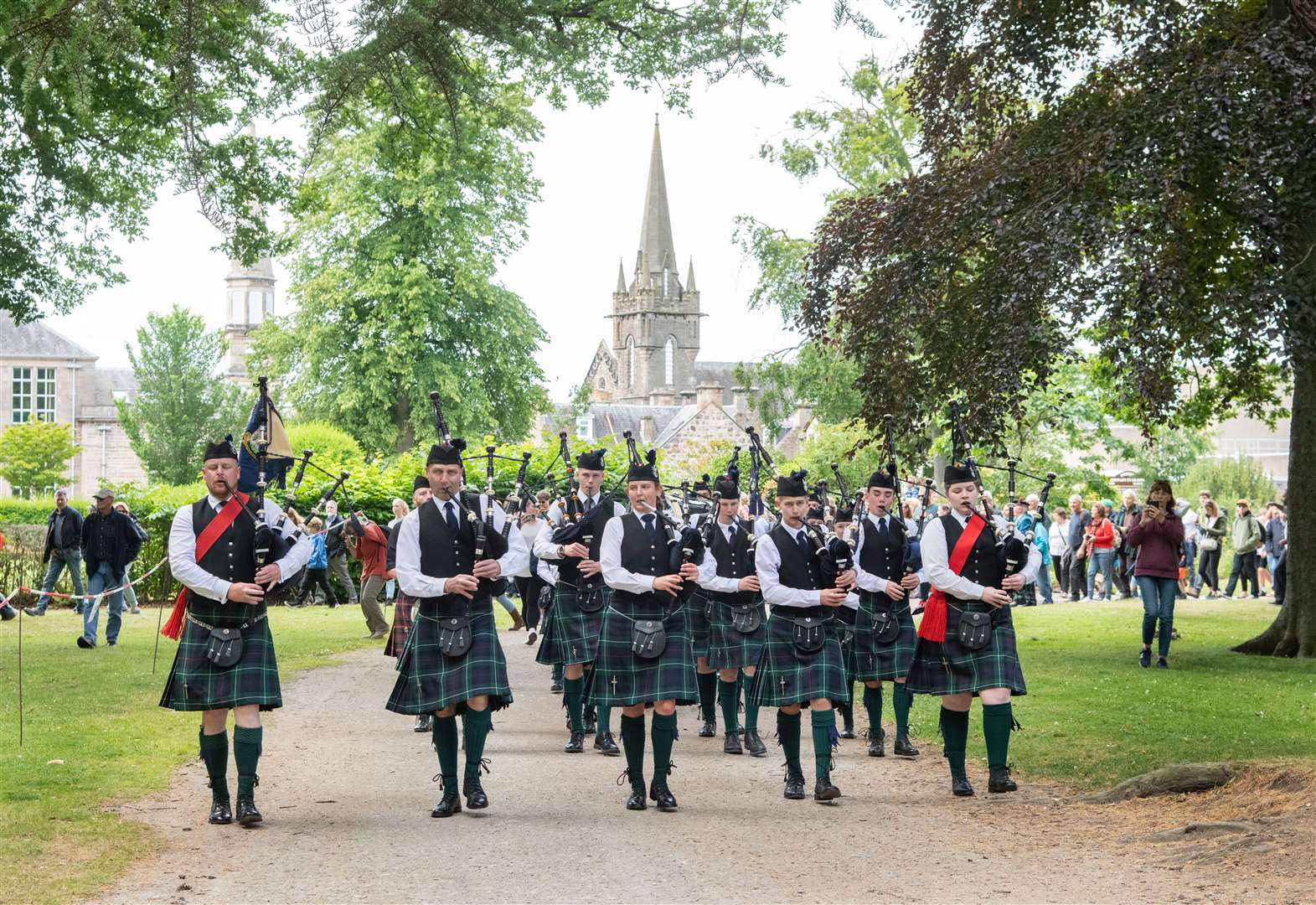The Forres and District Pipe Band march in to Grant Park ahead of the offical opening of the games...Forres Highland Games 2022...Picture: Daniel Forsyth..