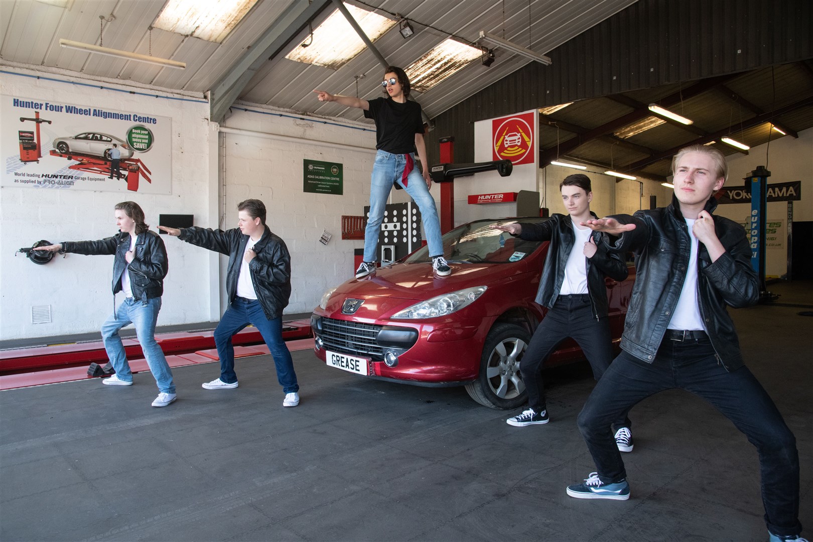 The seniors performed Greased Lightnin' in the GT Tyres garage ahead of their show. Picture: Daniel Forsyth