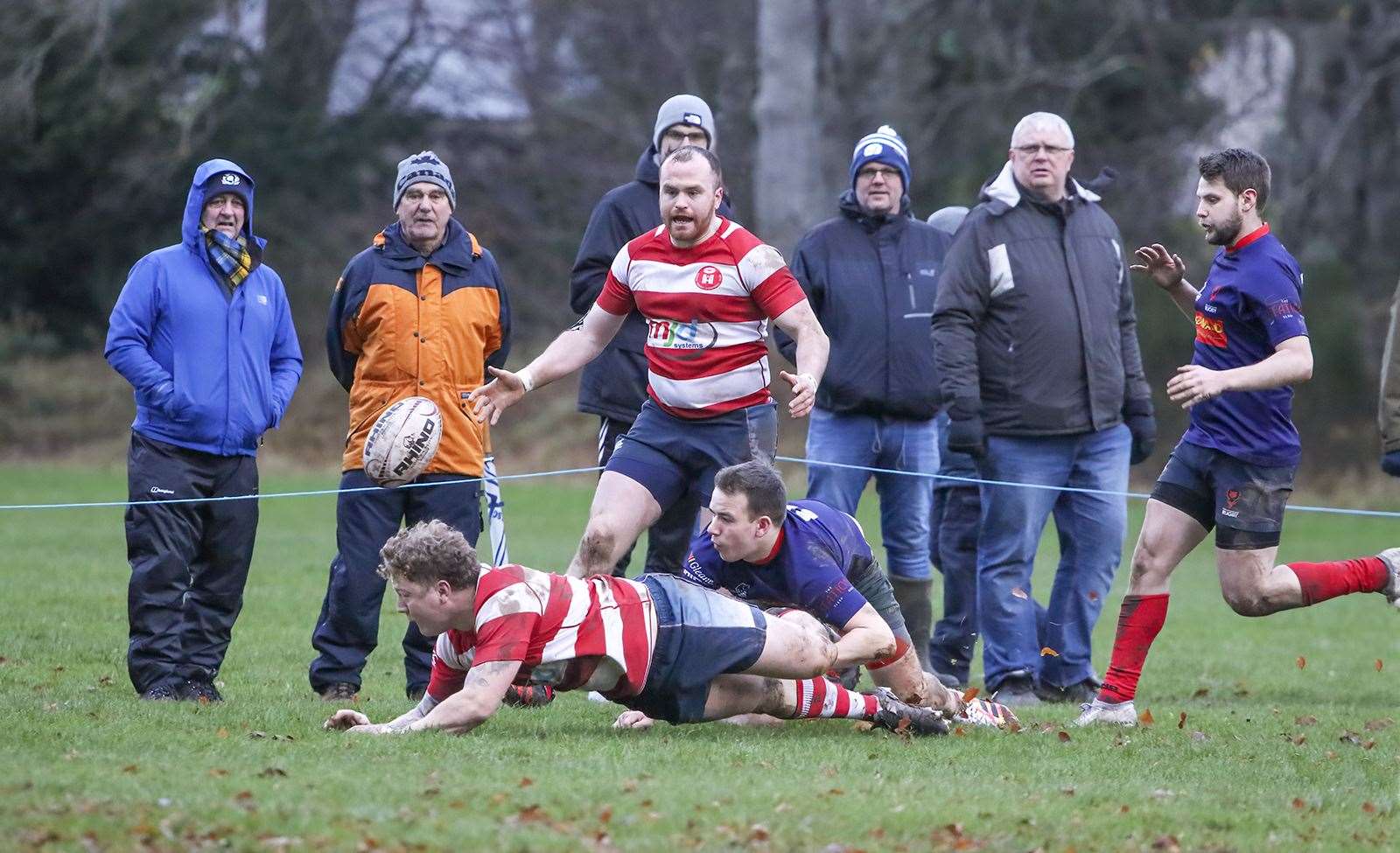 Lewis Scott tries to offload to Euan Kirkwood in the tackle. Photo: John MacGregor