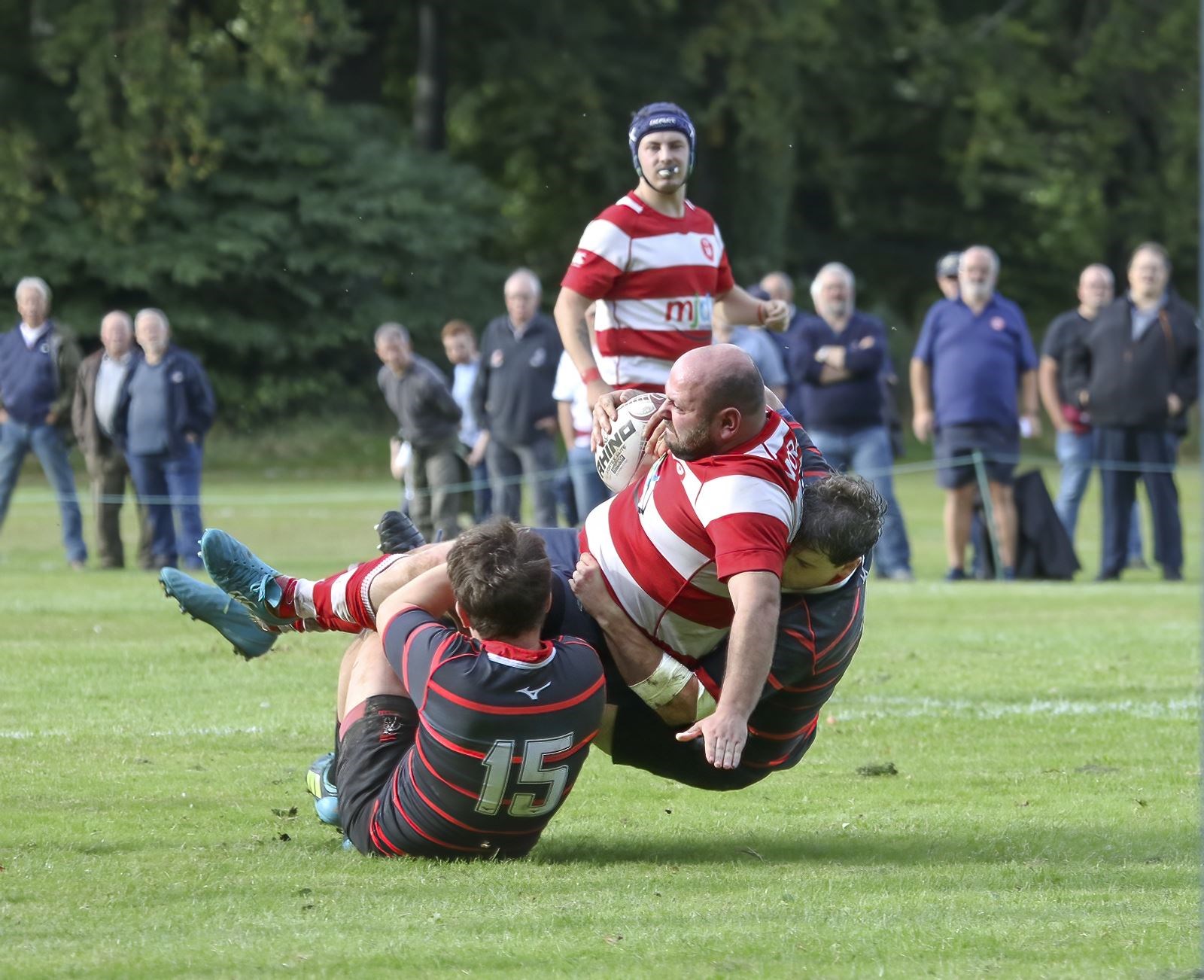 Marc Higgins is tackled as Connor McWilliam looks on. Photo: John MacGregor