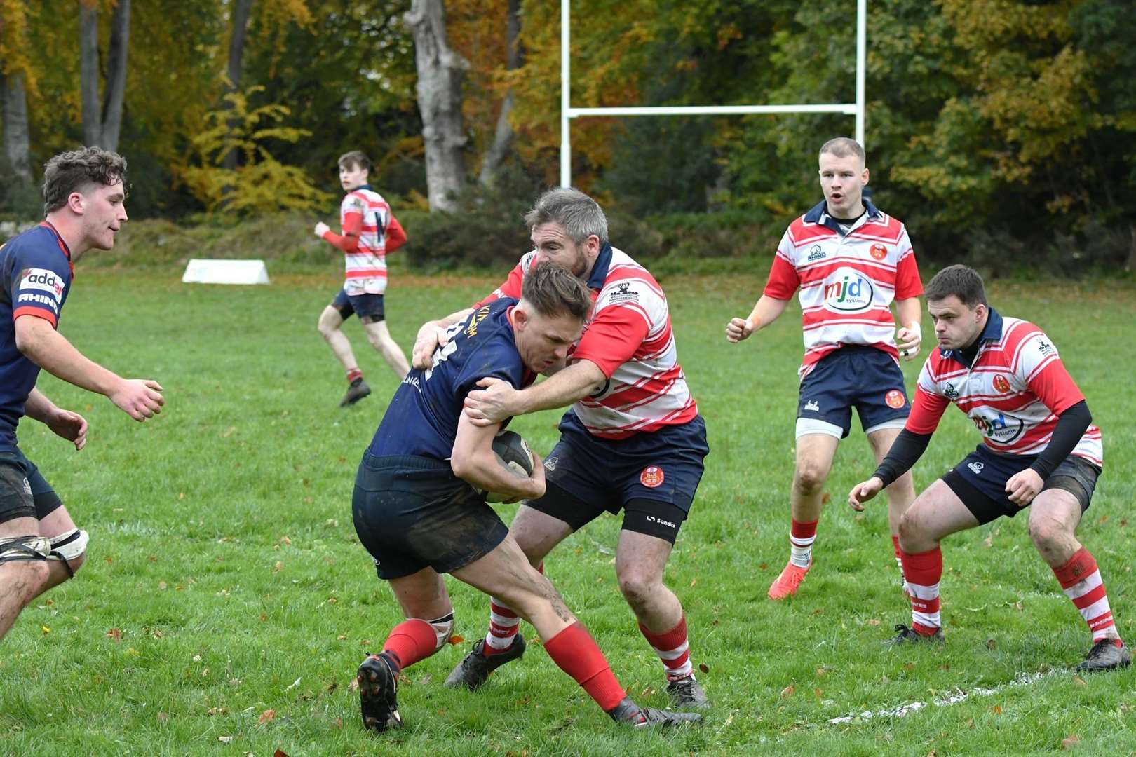 Chris Robottom stops attack. In the background are Gregor Hands and Lewis Hogg