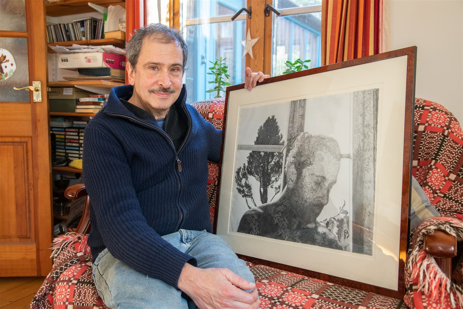 Randy Klinger with a portrait of himself drawn in pencil. Picture: Daniel Forsyth.