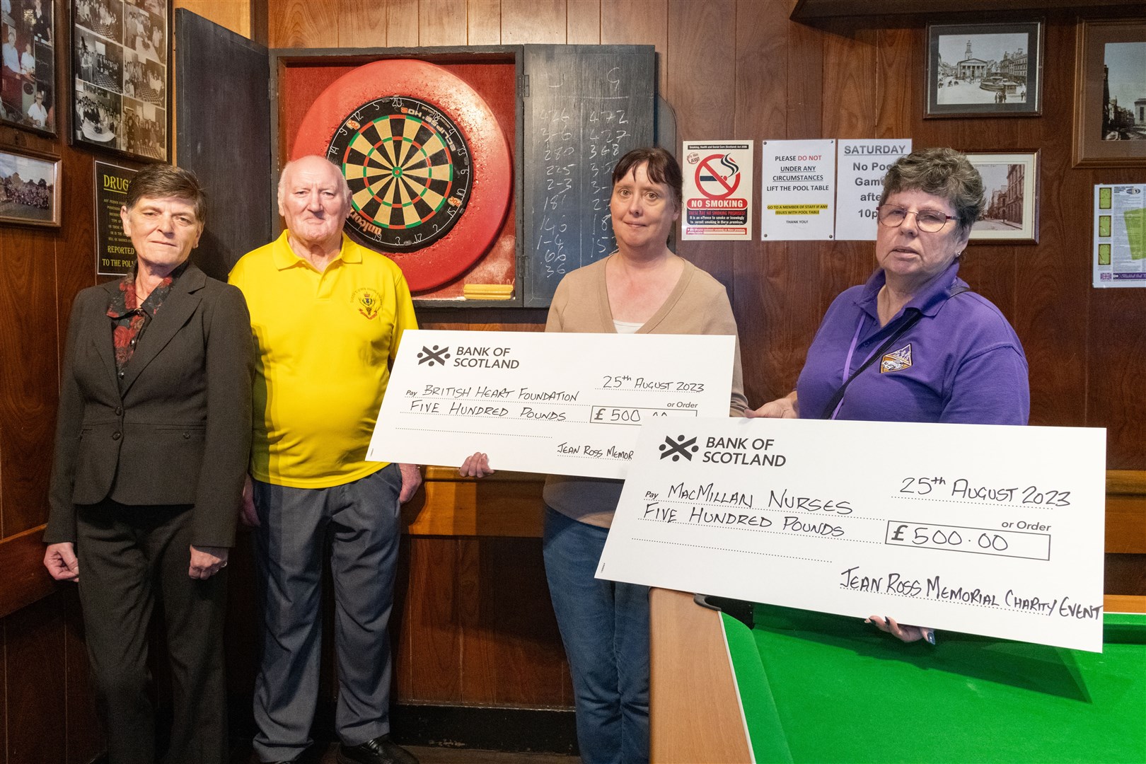 From left: Patricia Ross and Bill Ross handing over cheques for £500 to Marcelle Pratt (assistant manager at British Heart Foundation, Elgin) and Susan Lissamer (contract driver at C&R Taxi's) for Macmillan from the Jean Ross Memorial Charity Event...Picture: Beth Taylor.