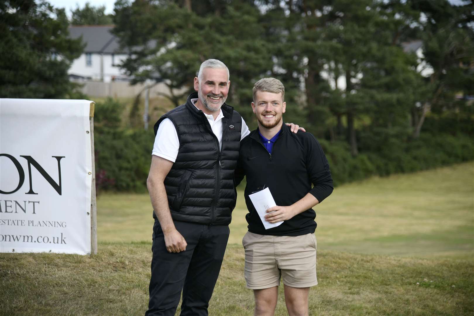 Ryan McPherson being presented a bottle of whisky by Martin Grierson...Elgin Five Day Open 2022...Picture: Beth Taylor.