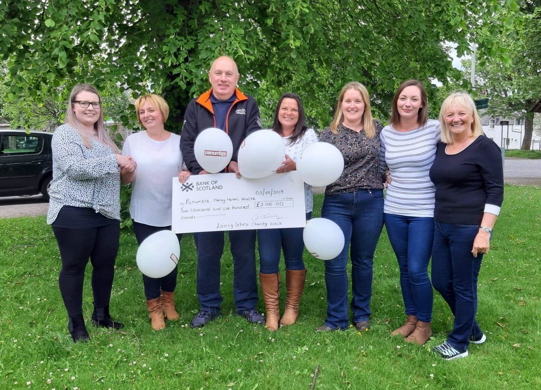 From left, Tomintoul walkers Dionne Sim, Andrew Sim, Janice Levack, Louise Stuart, Zoe Hamilton and Anne Phillips presenting the cheque to Sarah Mcgregor, from Moray Mental Health.