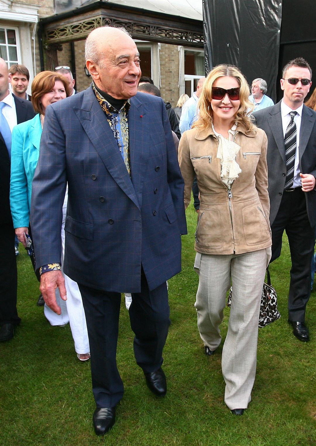 Mohamed Al Fayed with Madonna as she arrives at The New School in West Heath, Kent, for a fundraiser in 2010 (PA)