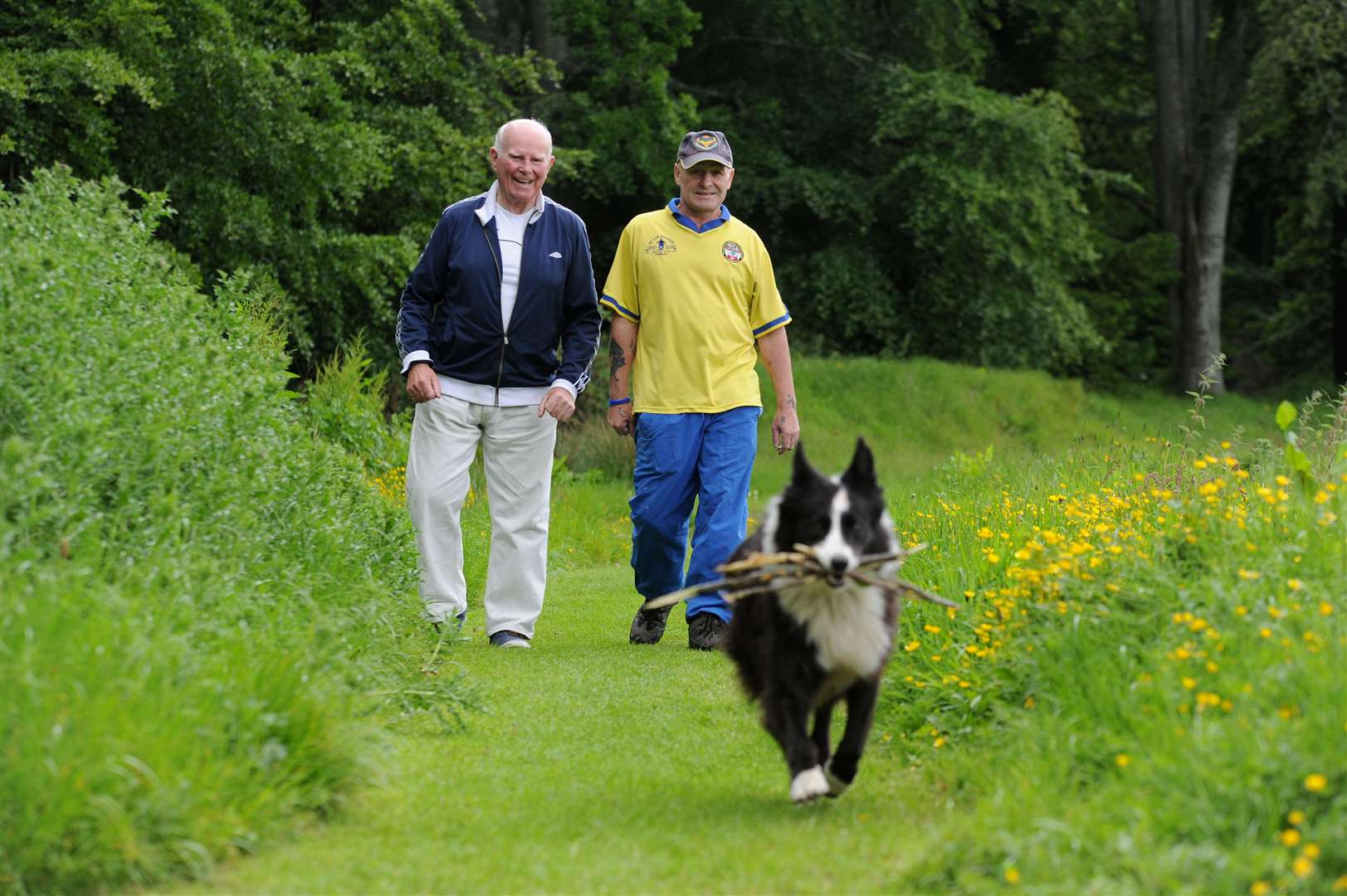 MIke Christe and Geordie Ross with Collie dog Glen at the overgrown playing fields