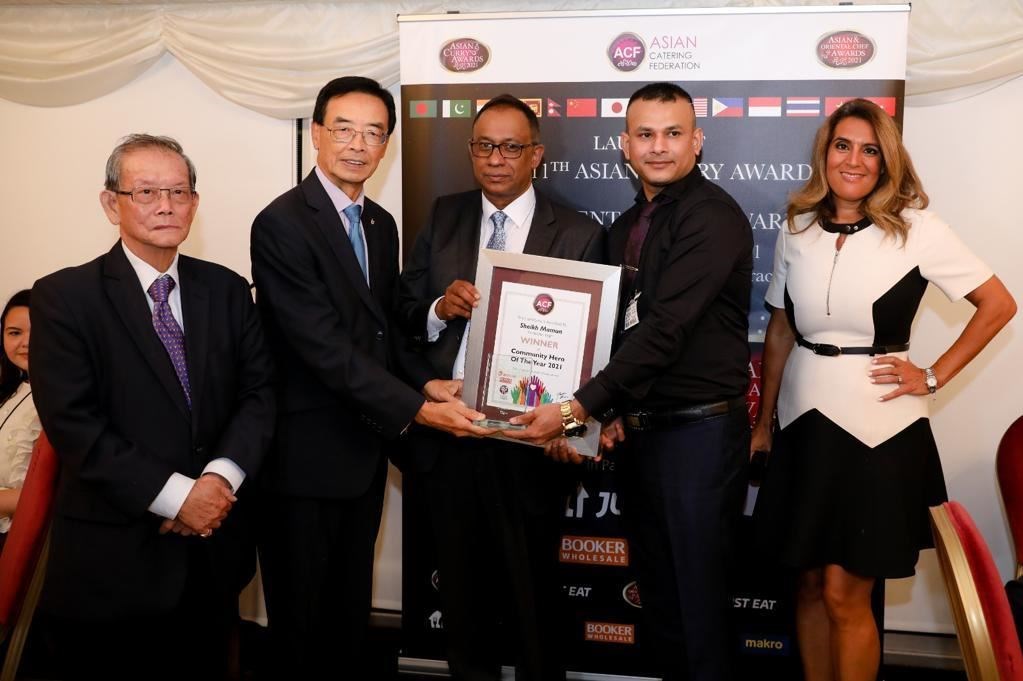 Panache Elgin manager Mamun Hussain (2nd right) being presented with his Community Hero award in London.