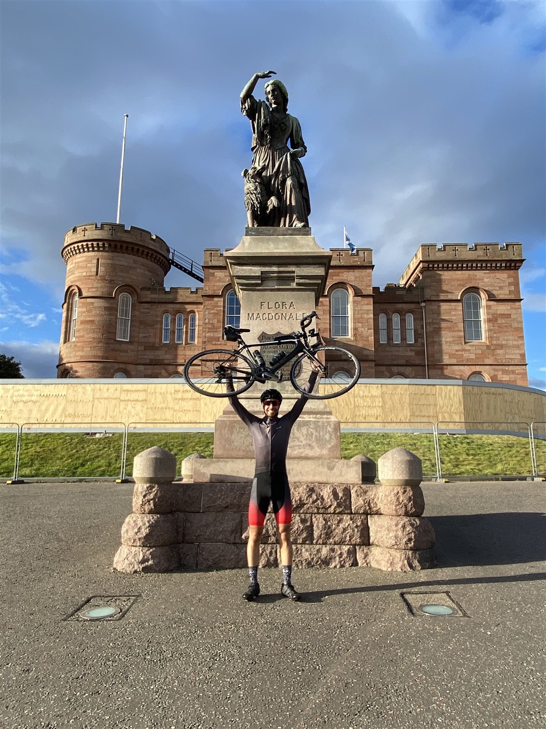 A bike lift in celebration at the finish line at Inverness Castle.