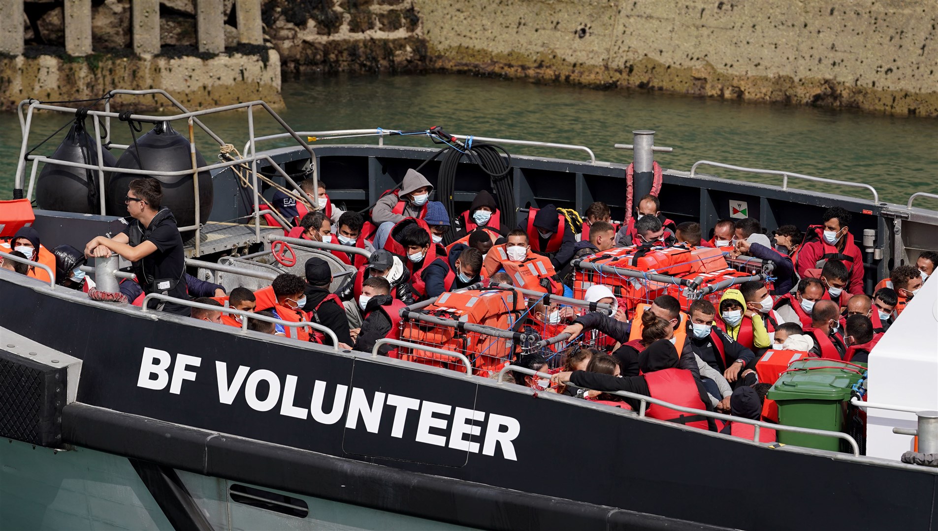 A group of people, thought to be migrants, are brought in to Dover, Kent, on board a Border Force vessel on Sunday (Gareth Fuller/PA)