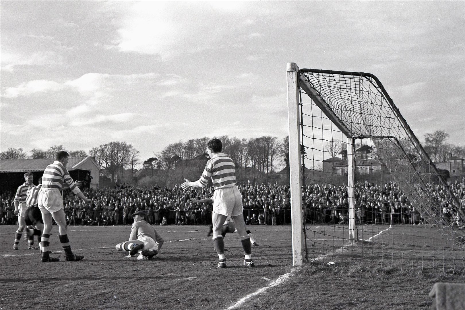 Action from the 1960 Scottish Cup tie against Celtic in front of what was at the time a record Borough Briggs crowd.