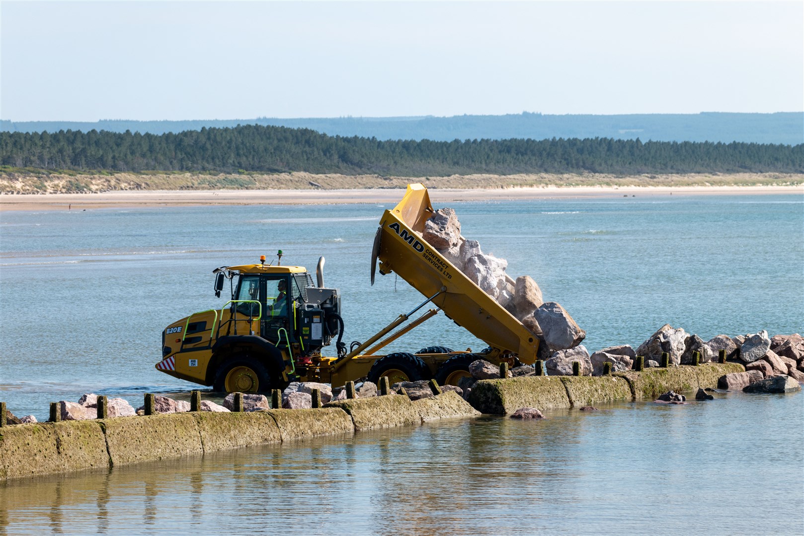 Repairs taking place to the old wooden and concrete exterior harbour breakwater. Picture: Jasperimage