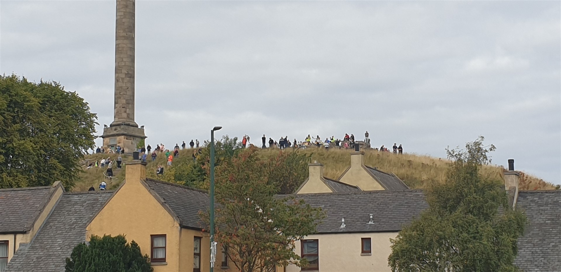 A large crowd gathered on top of Ladyhill to watch the aircraft fly over.