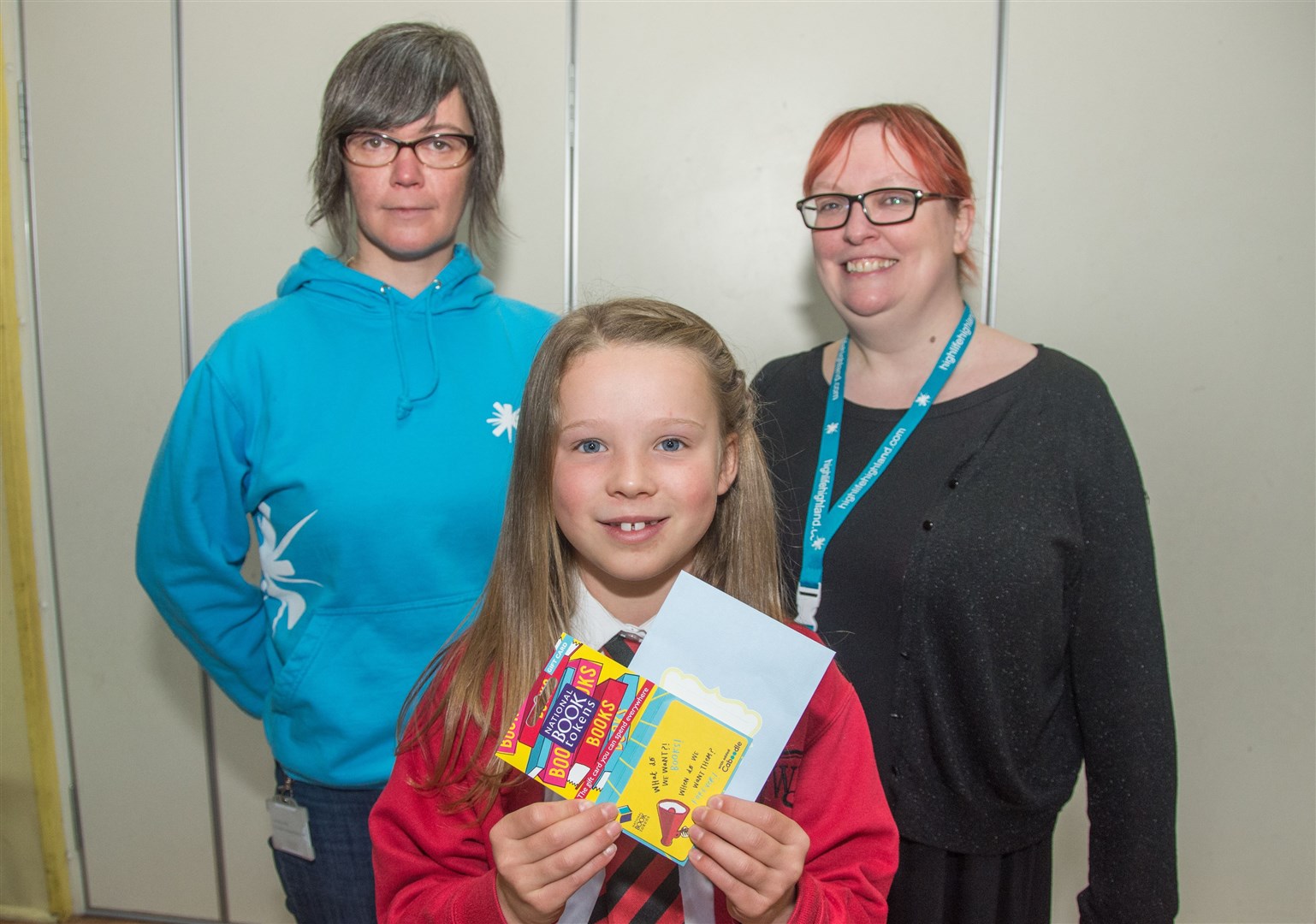 Ava Cant won writing competition organised by Inverness Museum...Curator Alison Parfitt and Librarian Sya Bruce hand over the gift card...Picture: Becky Saunderson. Image No.044041.