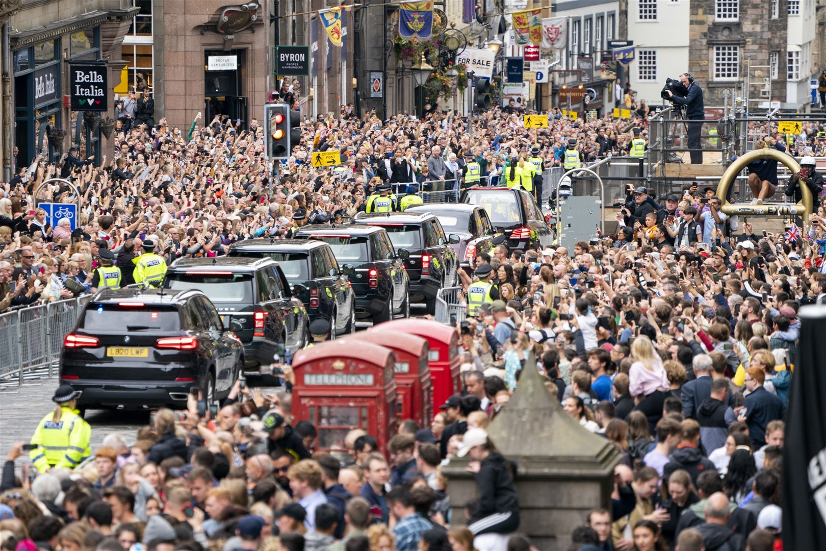 The cortege passes down Edinburgh’s Royal Mile on its journey from Balmoral to the Palace of Holyroodhouse (Jane Barlow/PA)