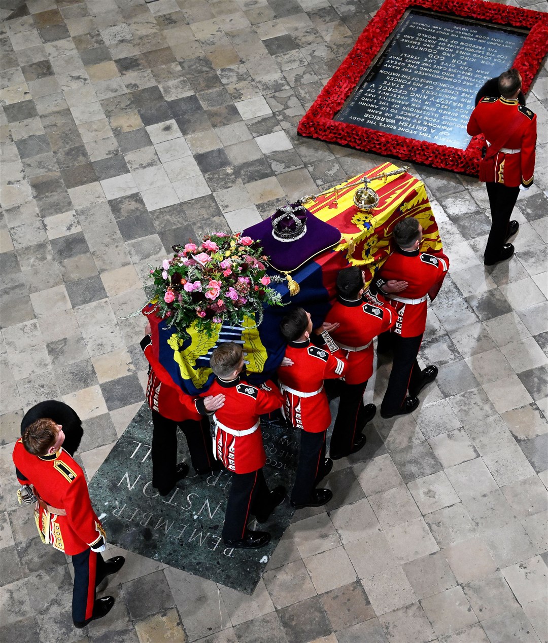 The coffin of the Queen with the Imperial State Crown resting on top is carried by the Bearer Party into Westminster Abbey (Gareth Cattermole/PA)