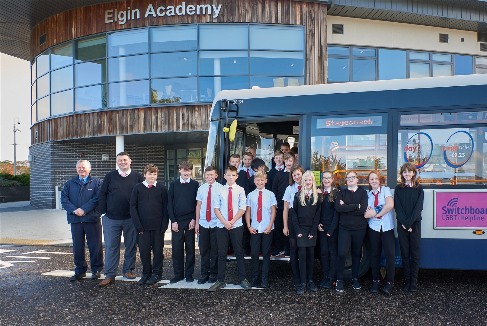 (From left) bus driver Jim McGiff and Stagecoach operations manager Jamie Reid with pupils from Elgin Academy. Picture: Gary Murison.
