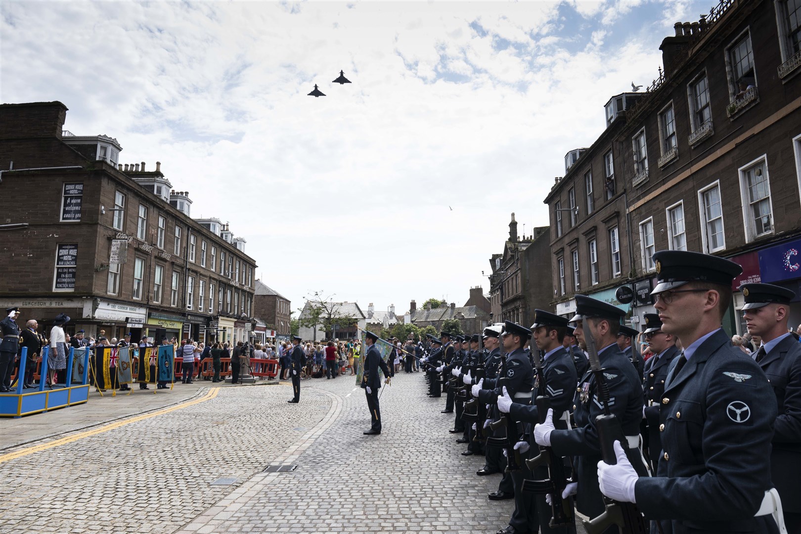 Image shows II (Army Cooperation) Squadrons’ Freedom of Angus Parade taking place in the High Street of Montrose, Angus on the 26th July 2019. The Parade consisted of 2 flights of 30 persons per flight, a standard party supported by the Central Band of the Royal Air Force as well as a flypast provided by the Lossiemouth Spt Party (LSP) to accept the Freedom of Angus from the Provost of Angus and exercise the Freedom by marching through Montrose. For the history of why the parade is taking place, The Royal Flying Corps was directed to and established 12 air stations in the Uk in the Autumn of 1912. The first was established by 2 Sqn RFC (No. II(AC) Sqn RAF) at Montrose in Feb 1913. Following ground-breaking deployments to Ireland and England and the setting of several distance and altitude records, the Sqn left Montrose for France and World War 1 in Aug 1914 never to return. In recognition of its contribution to the development of Airpower whilst stationed at Montrose and to the security and Defence of the UK since its formation in 1912, Angus Council has conferred the Freedom of Angus on II (AC) Sqn. Originator: Sqn Ldr Gibson Section: 2 Sqn Ext: *For more information contact Photographic Section, RAF Lossiemouth, IV31 6SD. Tel: 01343 817191
