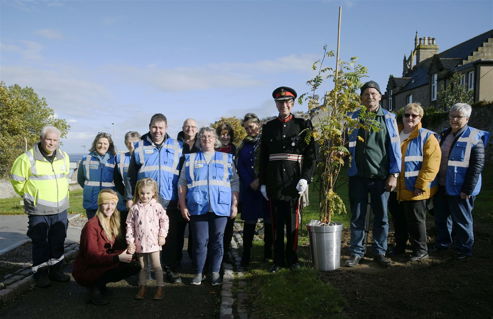 Lord Lieutenant of Banffshire Andrew Simpson (fourth right) presents Buckie's Roots with their 'Tree of Trees'. Picture: Beth Taylor