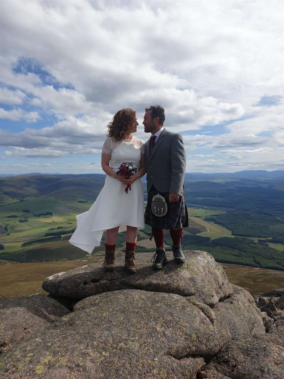 A kiss at the summit of Ben Rinnes seals the wedding of Ally Troon and Sarah Law.