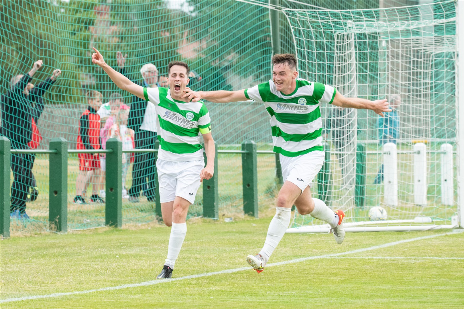 Kevin Fraser (left) wheels away to celebrate his last minute Buckie Thistle winner with team-mate Jack Murray. Picture: Daniel Forsyth..