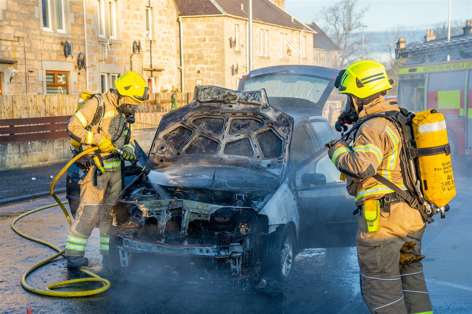 An Elgin fire appliance and a police car were in attendance after a black Fiat Punto car caught fire on Newmill Road in the Kingsmills area of Elgin. Picture: Daniel Forsyth.