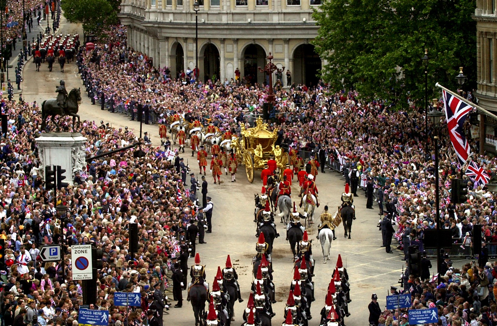 Crowds lining the street as the Queen rides in the Gold State Coach from Buckingham Palace to St Paul’s Cathedral in 2002 (Barry Batchelor/PA)