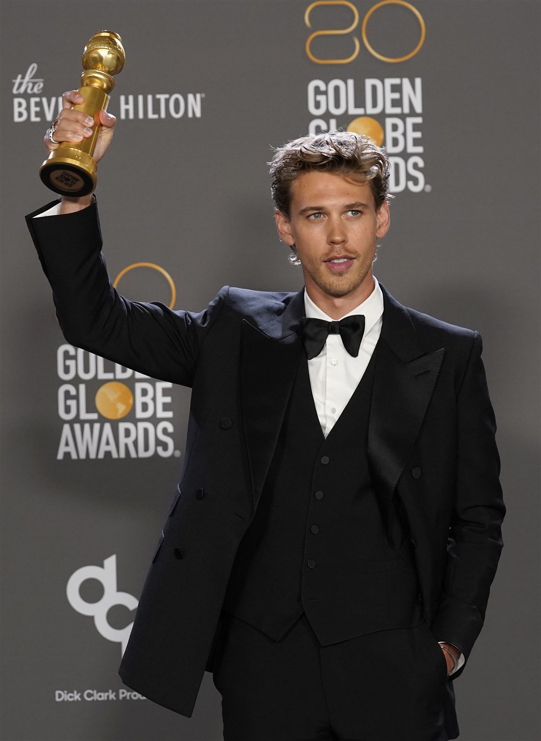 Austin Butler poses in the press room with the award for best performance by an actor in a motion picture: drama for Elvis (Chris Pizzello/Invision/AP)
