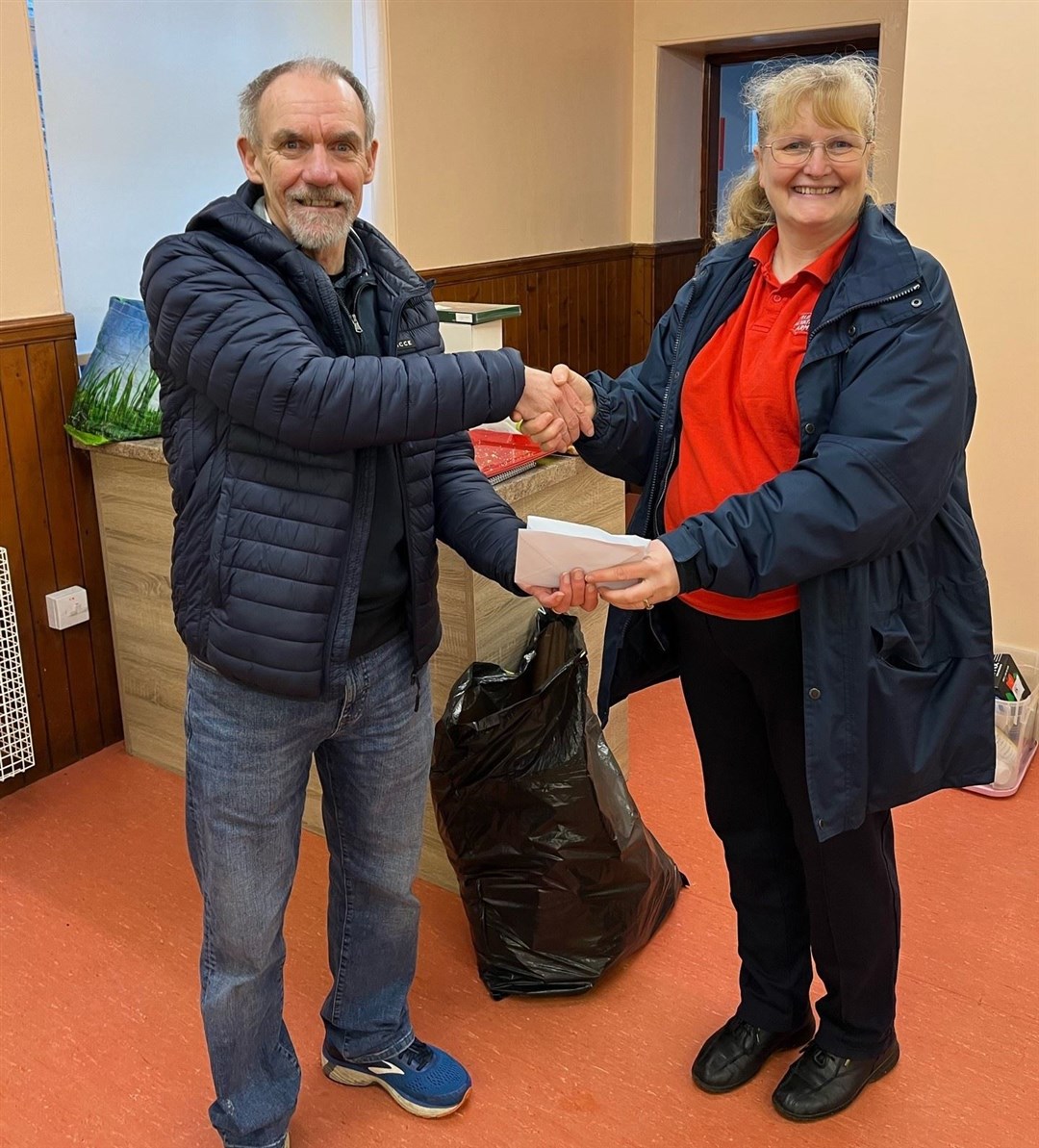 Race organiser hands over a donation of £502 to Lieutenant Theresa Raffan for Buckie Salvation Army food larder. Picture Sair Heidie race