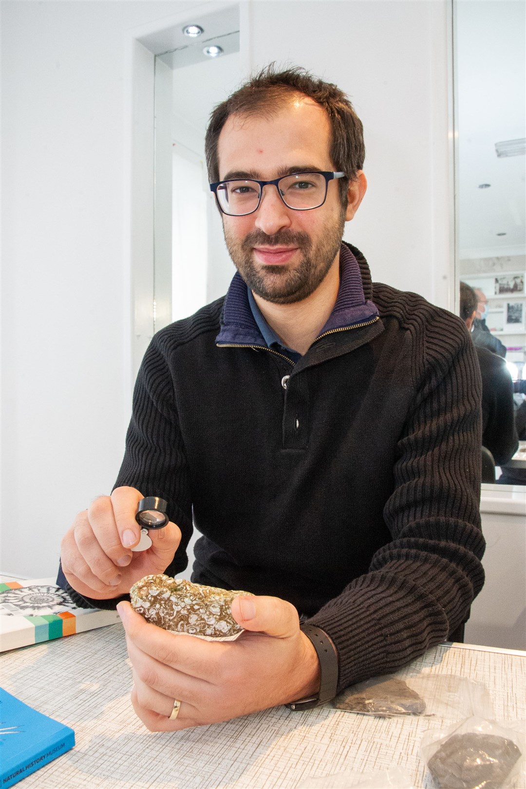 Dr Davide Foffa holds a Jurassic shelly limestone pebble found on Cummingston beach during Elgin Museum's drop-in event. Picture: Daniel Forsyth.