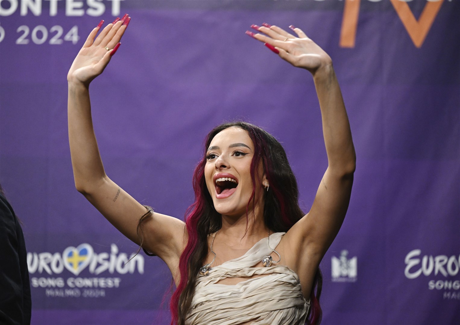 Eden Golan representing Israel waves during a press meeting with the entries that advanced to the final after the second semi-final of the Eurovision Song Contest (Jessica Gow/AP)