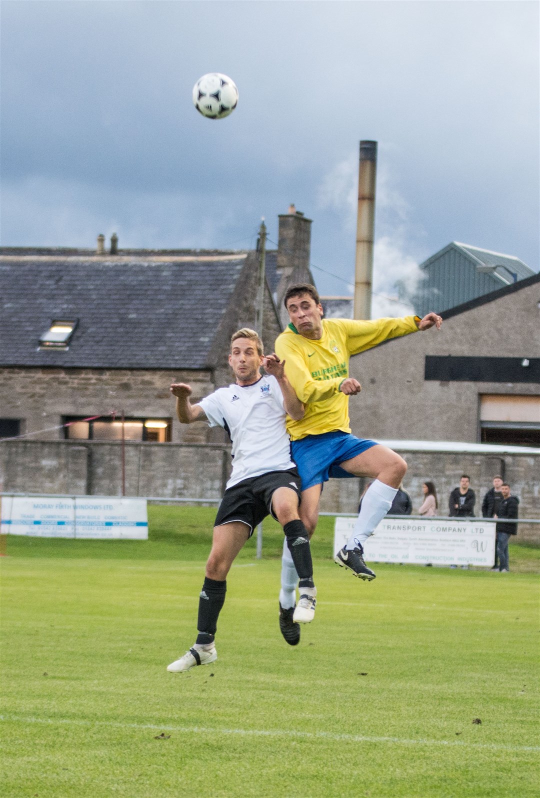 Hopeman's Graeme Ingram up for the ball with Burghead's Jake Sutherland. Pictures: Becky Saunderson. Image No. 044672.