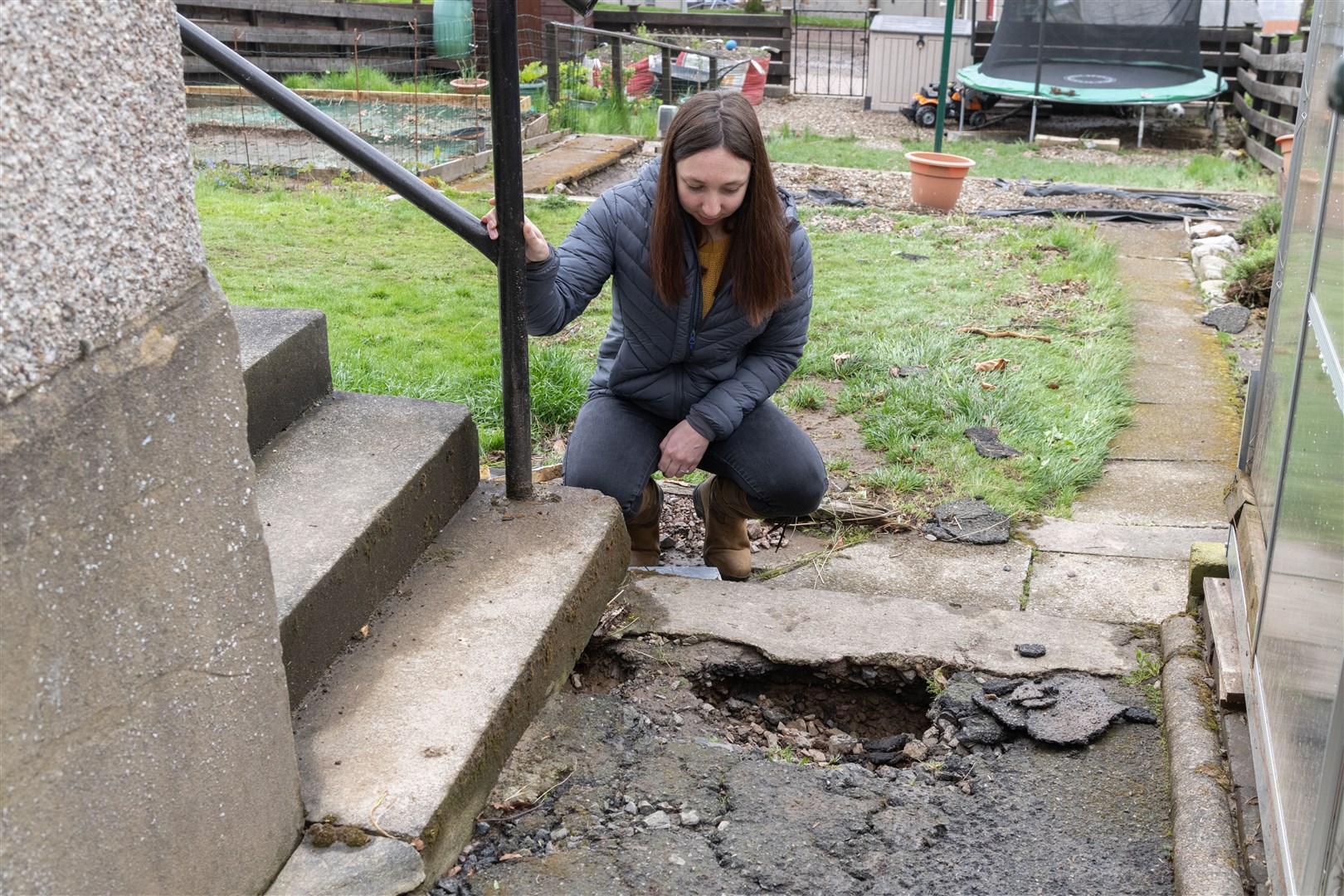 Amy Tait looking at her path that was destroyed by the floods in Aberlour...Picture: Beth Taylor.